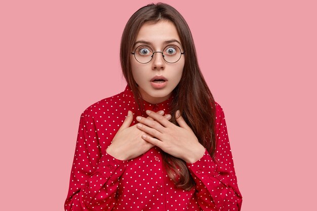 Portrait of woman in red shirt and round eyeglasses