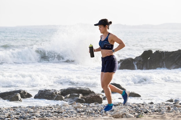 Portrait woman running at seaside