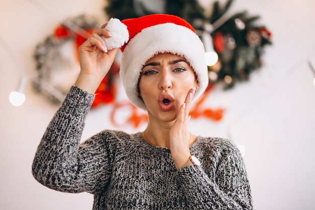 Portrait of woman in santa hat on Christmas