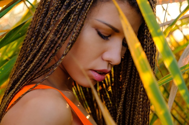 Free photo portrait of  woman in swimsuit among plants