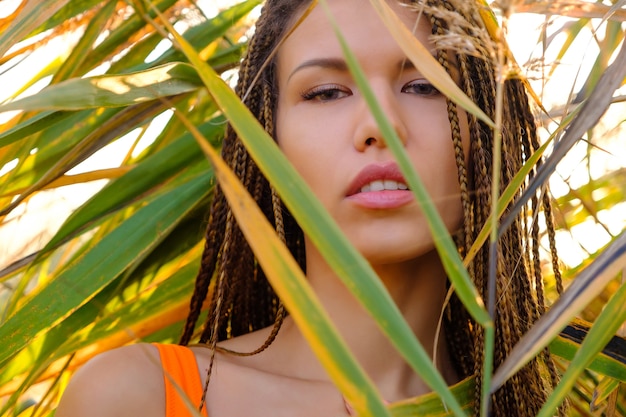 Portrait of  woman in swimsuit among plants