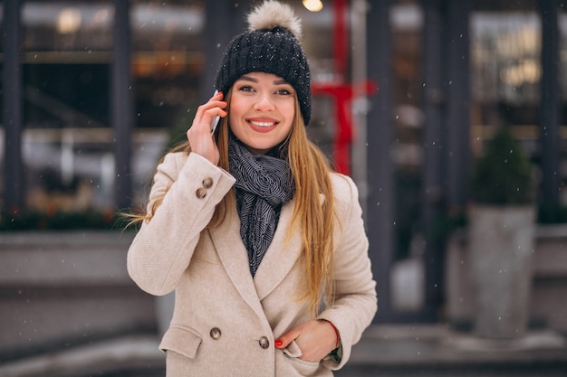 Portrait of woman talking on phone in the street