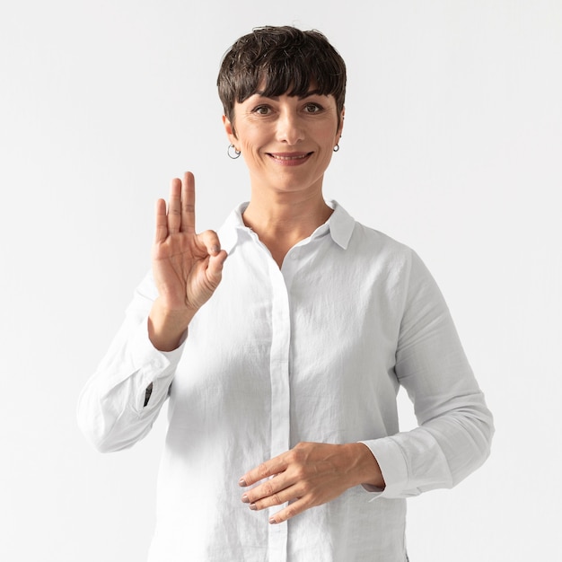 Portrait of woman teaching sign language