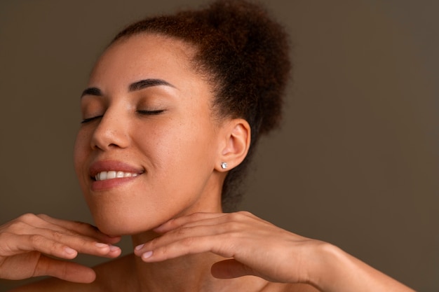 Portrait of woman trying facial yoga massage to stay young