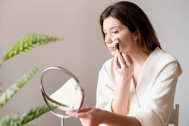 Portrait woman using brush for foundation