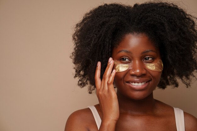 portrait of woman using eye patches for beauty