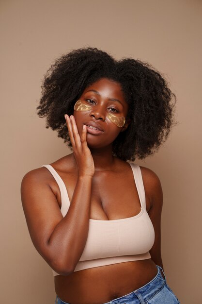 portrait of woman using eye patches for beauty