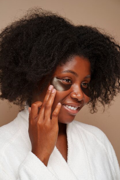 portrait of woman using eye patches for beauty