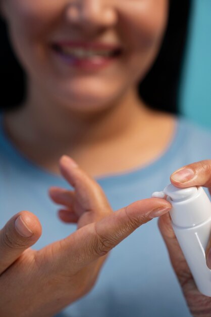 Portrait of woman using moisturizer