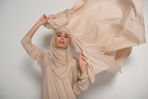 Portrait of woman wearing hijab isolated
