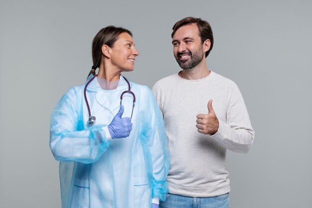 Portrait of woman wearing medical gown and male patient