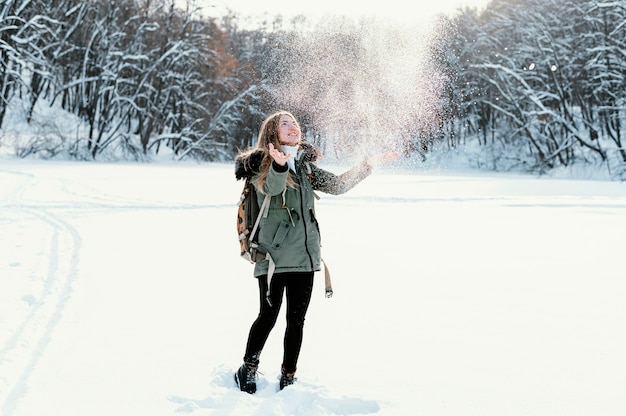 Portrait woman with backpack on winter day