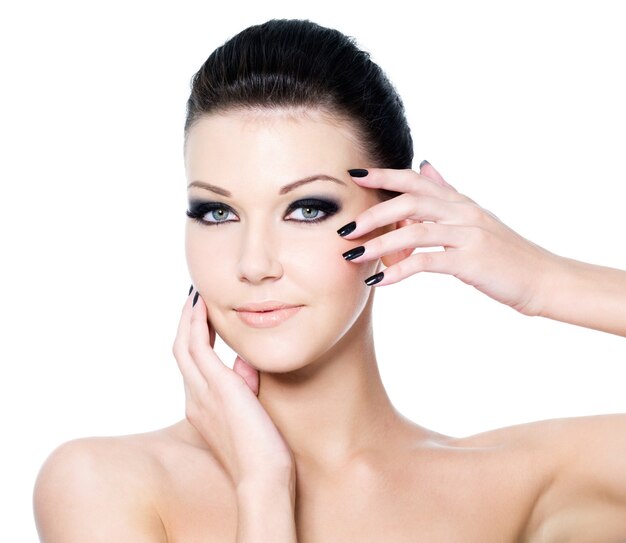 Portrait of a woman with Beautiful black eye make-up and beauty manicure