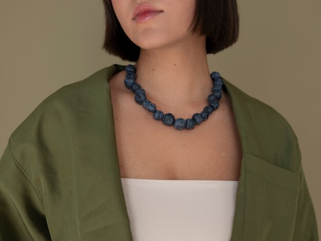 Portrait of woman with blueberry necklace