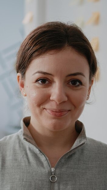 Portrait of woman with bottle of beer in hand for drinks after work in office. Adult holding alcoholic beverage to celebrate party and do fun activity after hours with workmates.