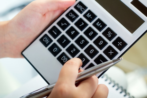 portrait of woman with a calculator and pen