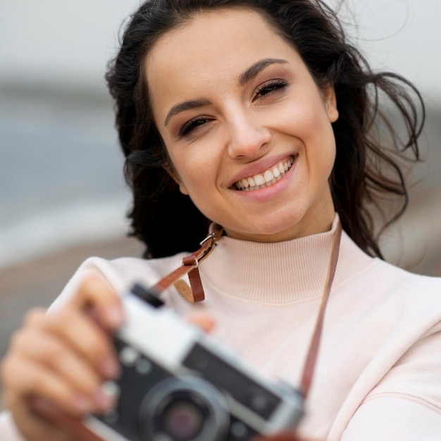 Free photo portrait woman with camera