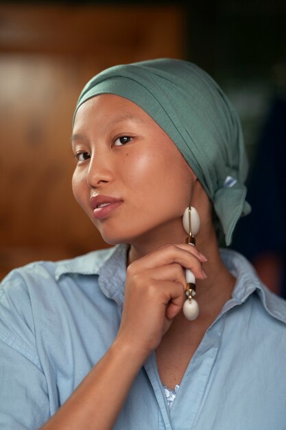 Portrait of woman with cancer doing her skincare at home