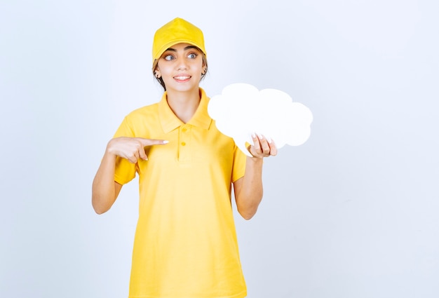 Portrait of a woman with an empty white speech bubble cloud pointing away . 
