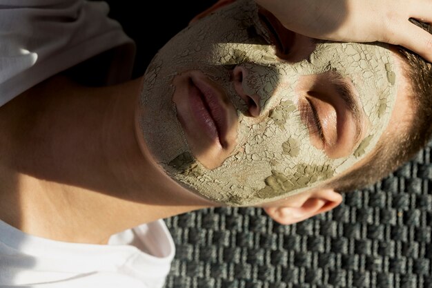 Portrait woman with facial mud treatment