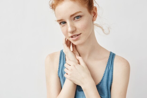 Portrait of woman with foxy hair posing smiling.