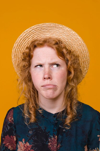 Portrait of woman with ginger hair fooling around in studio