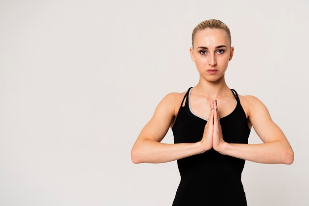 Portrait woman with hands united at chest