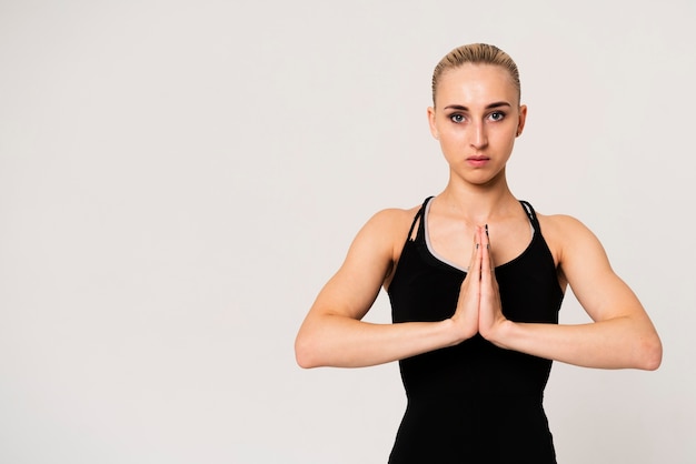 Portrait woman with hands united at chest