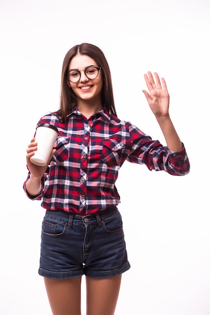 Portrait of woman with hello gesture drink tea or coffee from paper cup on white.