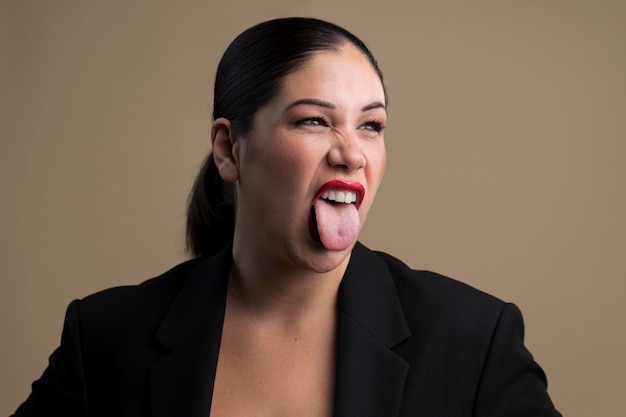 Free photo portrait of woman with her tongue out