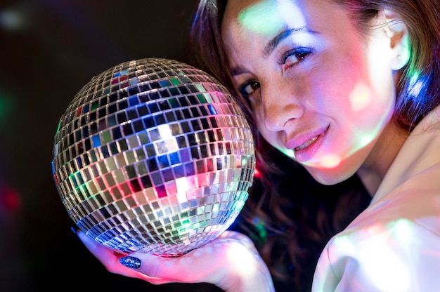 Free photo portrait woman with party globe
