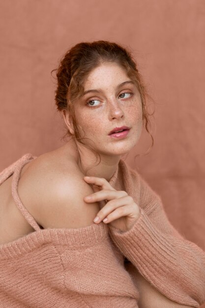 Portrait of woman with pink sweater and naked shoulder