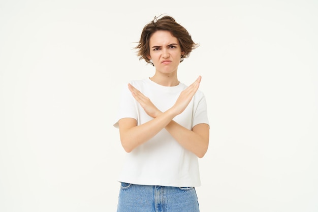 Free photo portrait of woman with serious face shows cross stop gesture prohibit something bad standing over