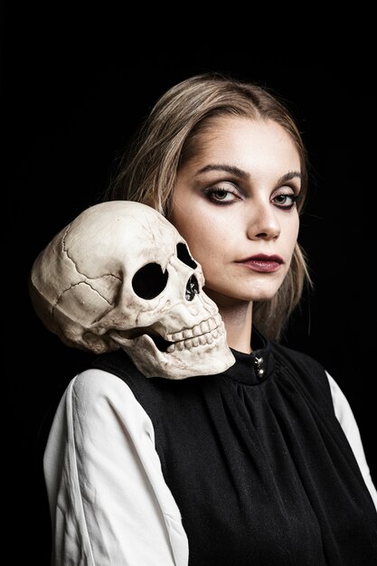 Portrait of woman with skull on shoulder