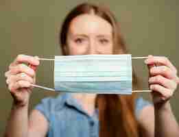 Free photo portrait woman with surgical mask