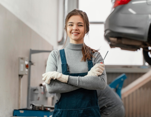 portrait of woman working at a car service
