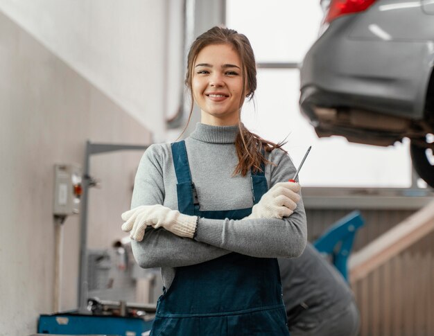 Portrait of woman working at a car service