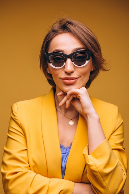 Portrait of woman in yellow suit isolated