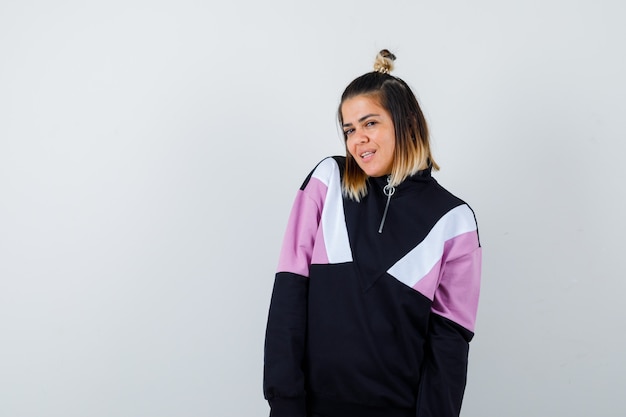 Portrait of wonderful lady posing while standing in sweatshirt and looking confident