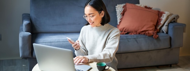 Foto gratuita ritratto di una donna d'affari che lavora utilizzando un laptop lavora su una ragazza coreana remota con negozi di computer online