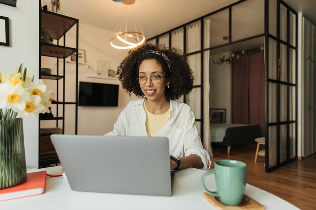 Portrait working young woman at home