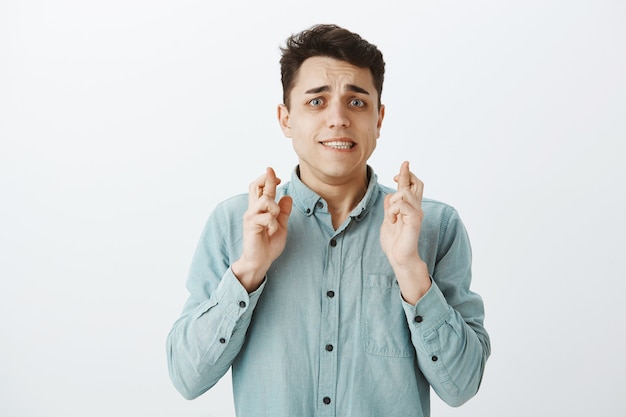 Portrait of worried doubtful caucasian guy in shirt