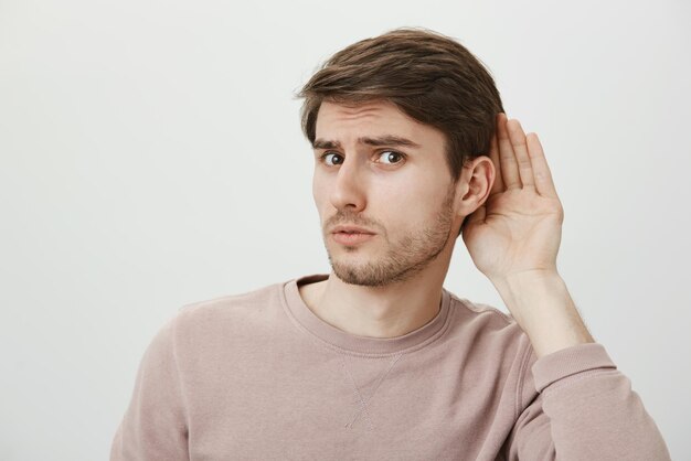 Portrait of worried guy having trust issues frowning and looking anxious