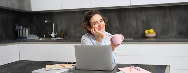 Free photo portrait of years woman studies online watches course in internet works on laptop from her home