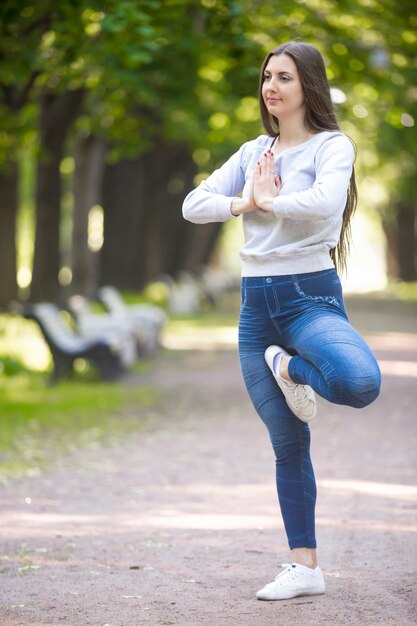 Portrait of yogi woman standing in Vrikshasana pose