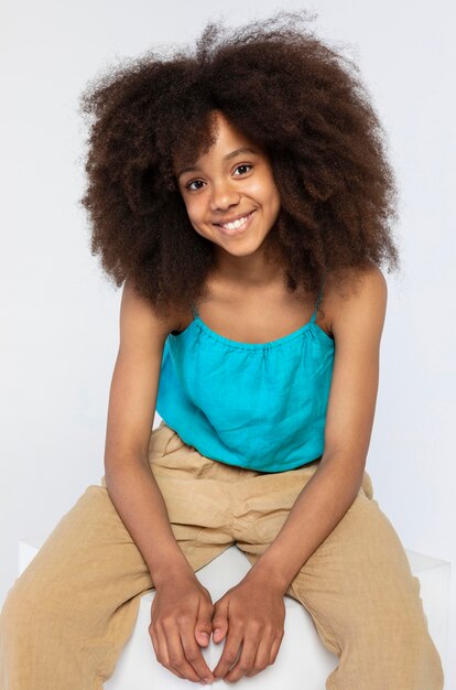 Portrait of young adorable girl posing in a cute top