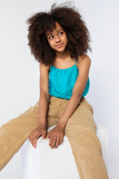 Portrait of young adorable girl posing in a cute top