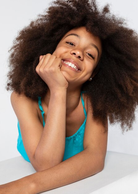 Portrait of young adorable girl posing in a cute top