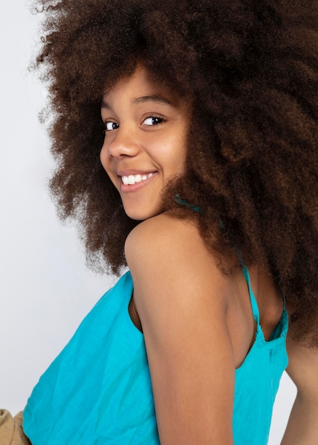 Free photo portrait of young adorable girl posing in a cute top