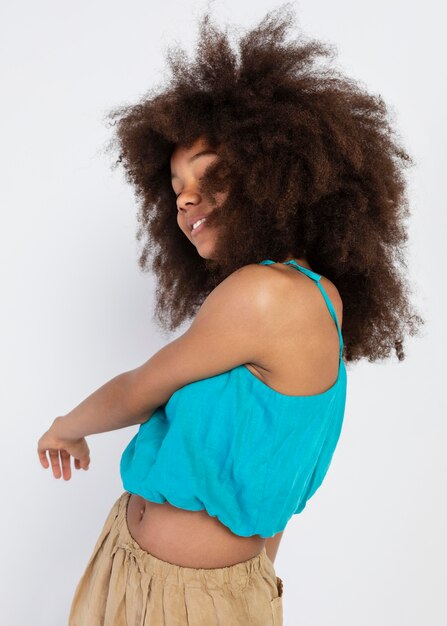 Portrait of young adorable girl posing in a cute top